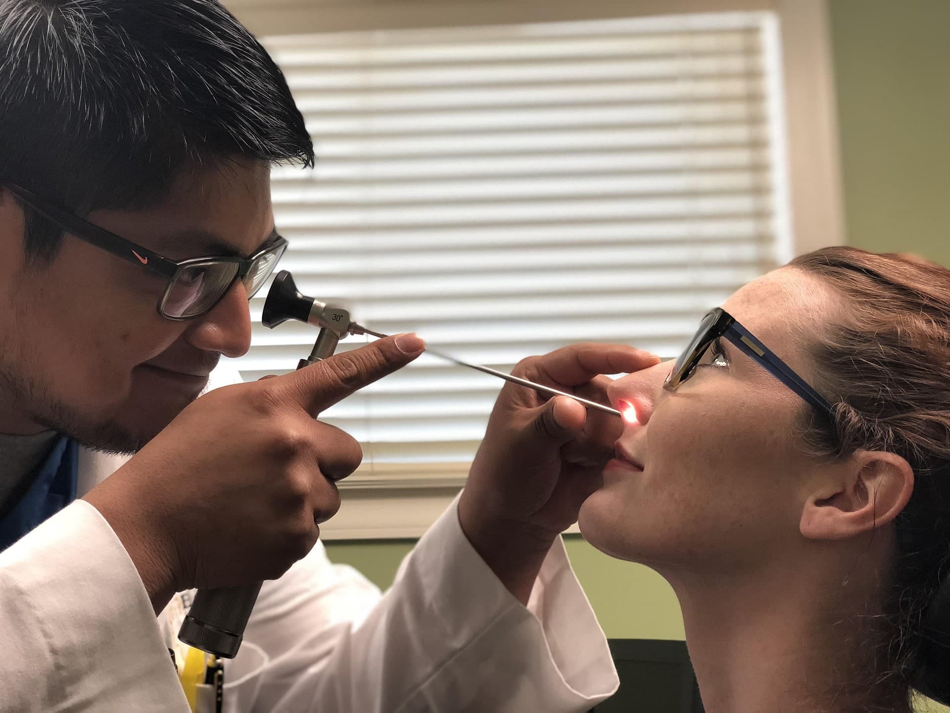 ENT specialist performing a nasal exam