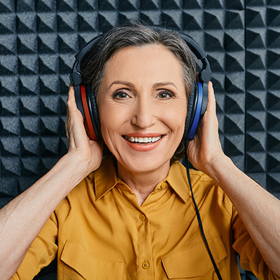 Women in a hearing booth having her hearing tested.